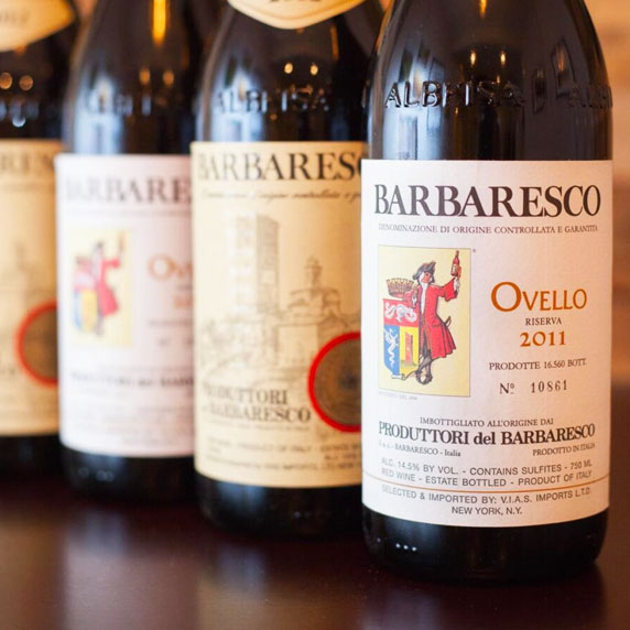 Bottles of Barolo wine and glasses of Vermouth