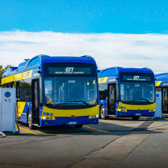 Buses circulating through the streets of Turin